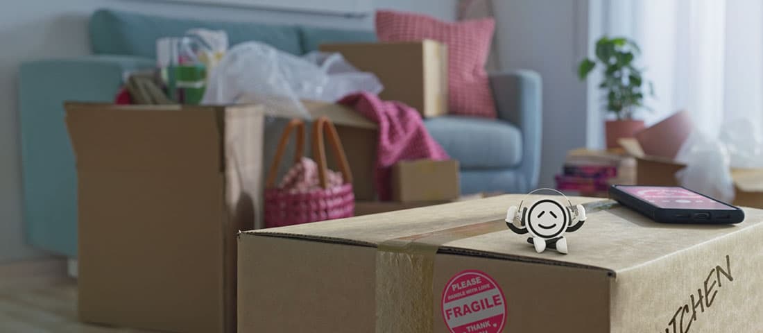 Powershop mascot Winky sitting on a moving box